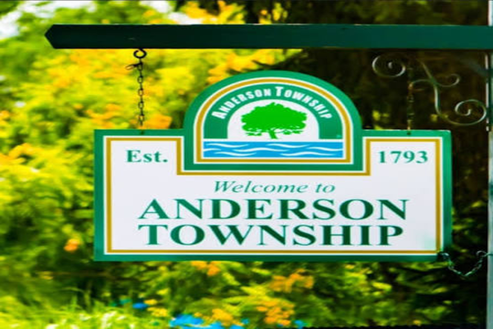 Anderson Township - ABS Services Welcome to Anderson Township sign hanging from a post, featuring a green tree emblem and est. 1793, set against a flowering background.